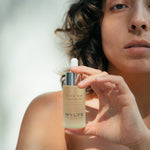 WYLYS Double Rose Luminizer Bottle held by Woman When You Love Your Skin
