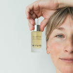 WYLYS Liquid V-Lift One-Step Serum Bottle held by Woman When You Love Your Skin