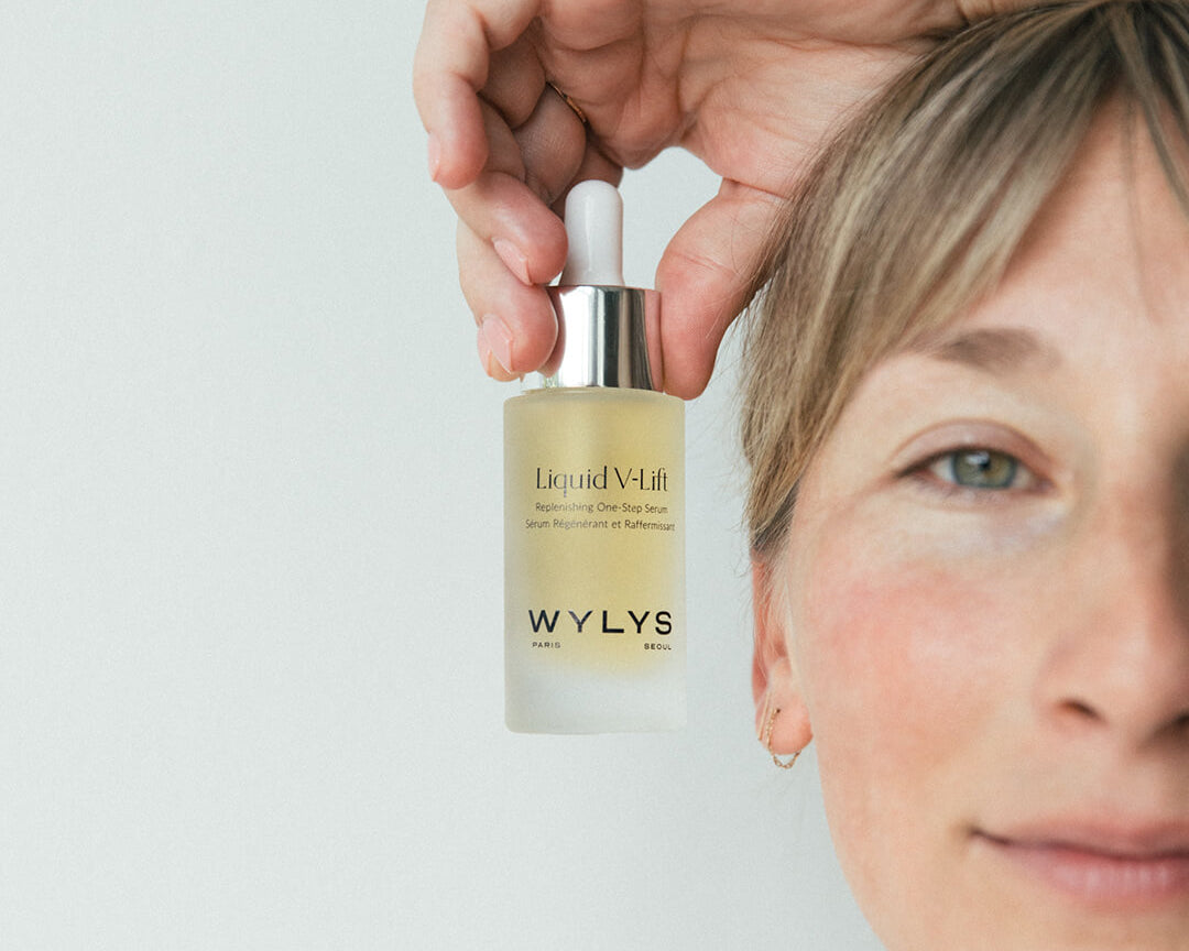 WYLYS Liquid V-Lift One-Step Serum Bottle held by Woman When You Love Your Skin