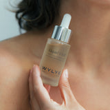 WYLYS Liquid V-Lift One-Step Serum Bottle held by Woman When You Love Your Skin