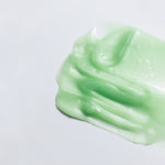 Texture shot of WYLYS Phyto Green Cleansing Balm showing its semi-transparent green gel-to-oil consistency.