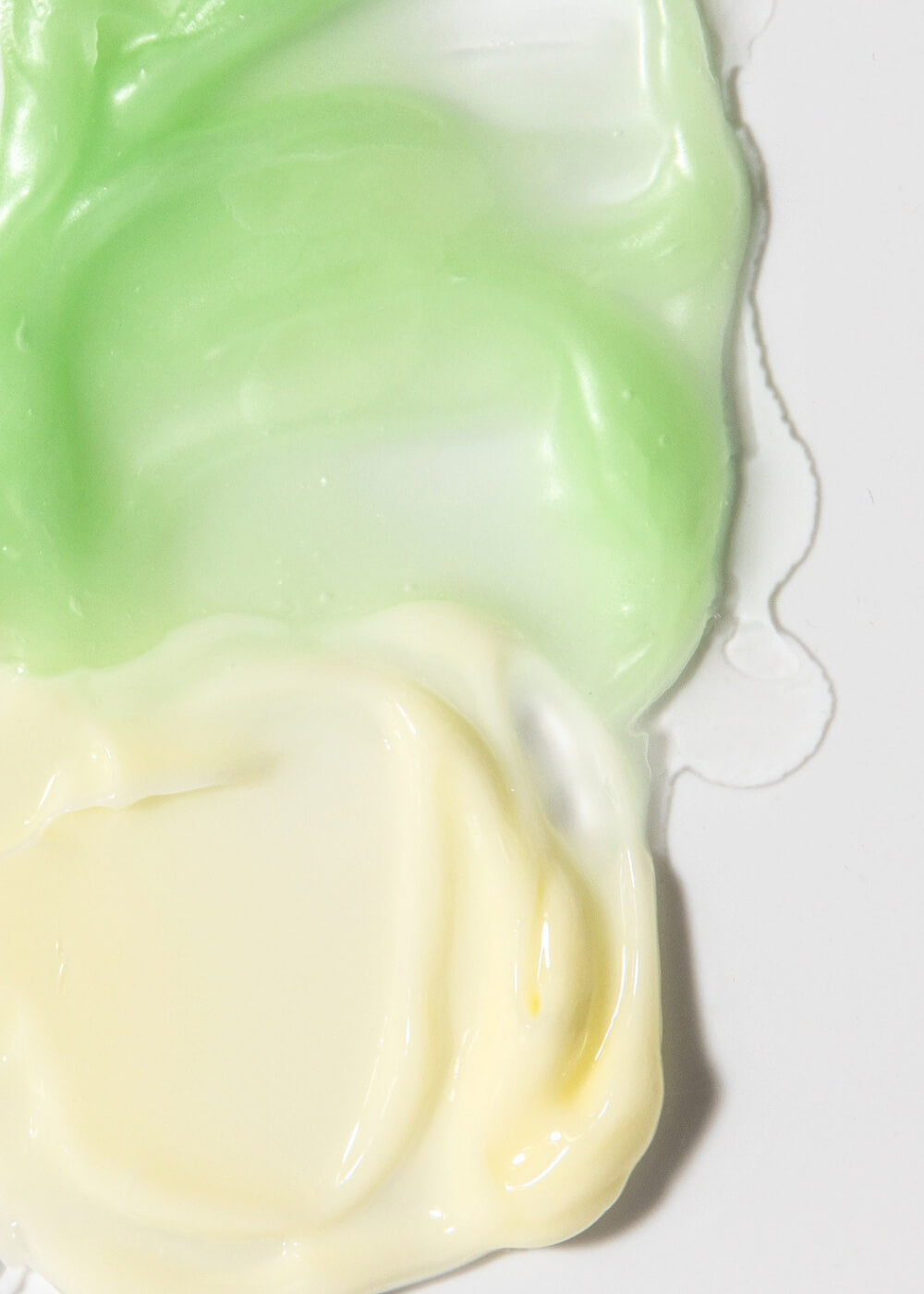 Close-up of a green and white swirled dessert on a white background