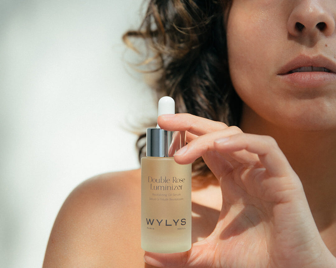 WYLYS Double Rose Luminizer Bottle held by Woman When You Love Your Skin