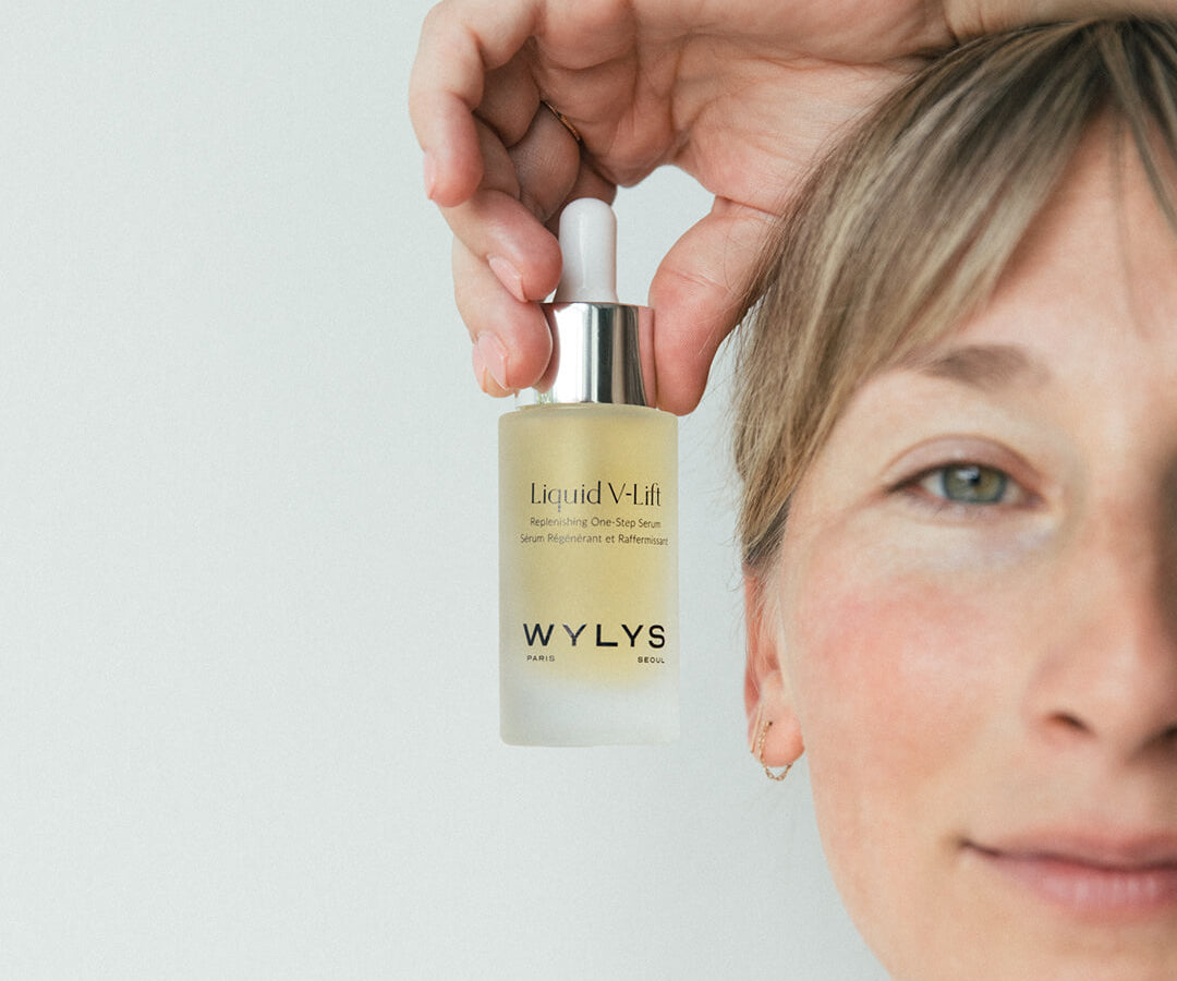 WYLYS Liquid V-Lift One-Step Serum Bottle held by Woman When You Love Your Skin